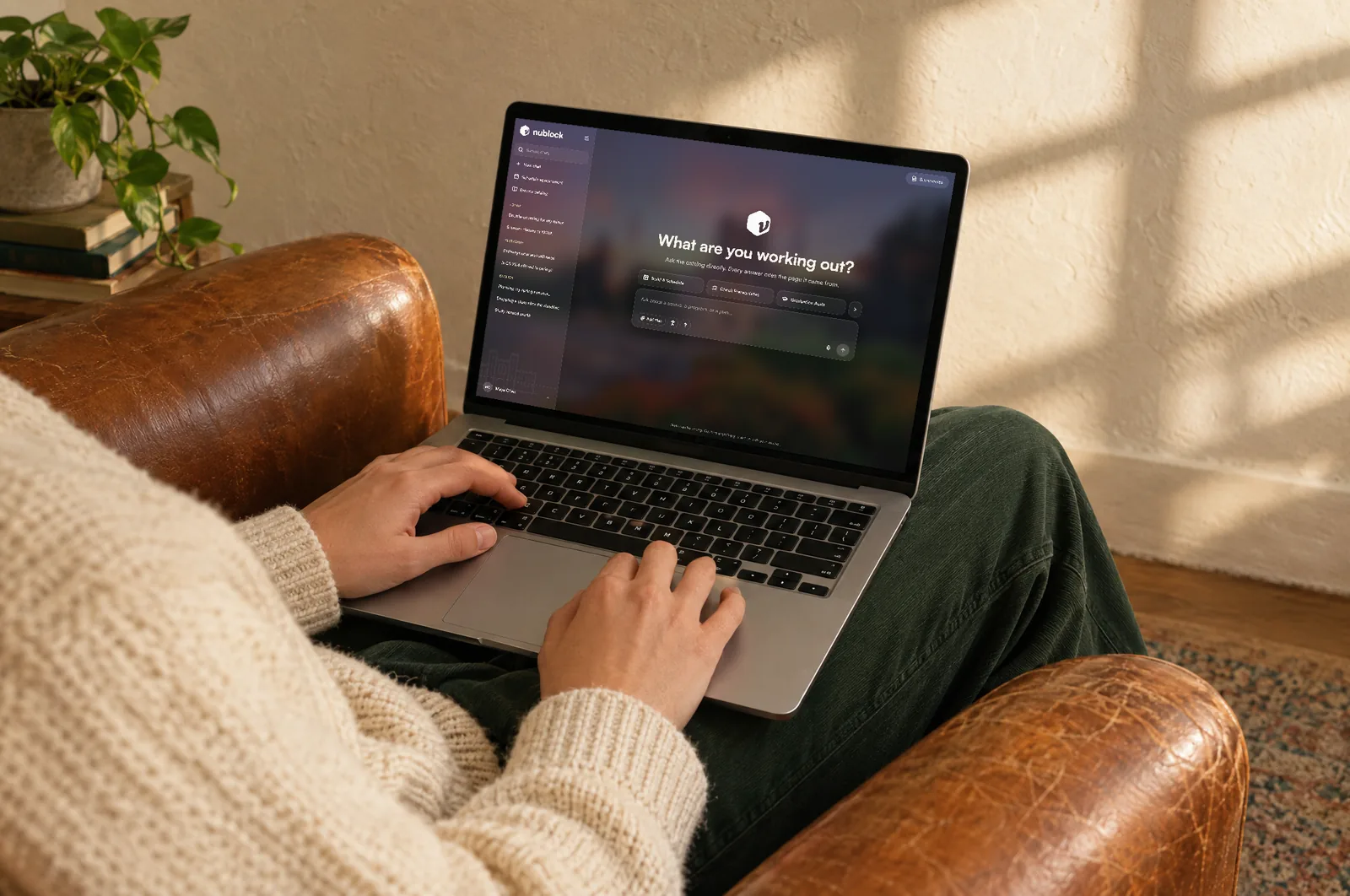 Ndex on a laptop, on a student’s lap in a leather armchair